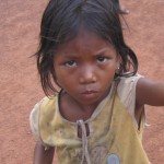 Child Begging by the roadside from passing traffic