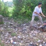 GCC local staff raking piles of rubbish for recycling (ENP)